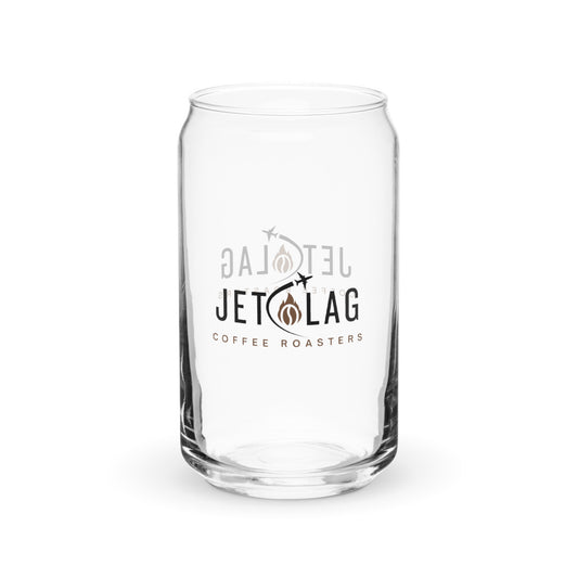 The image is of a clear glass shaped like a soda can. The glass has a logo for "Jet Lag Coffee Roasters" printed on it. The logo features the text "JET LAG" with an illustration of two small airplanes and a stylized coffee bean and flame. The words "COFFEE ROASTERS" are printed below the main logo. The glass appears to be designed for holding beverages, likely coffee or other drinks.